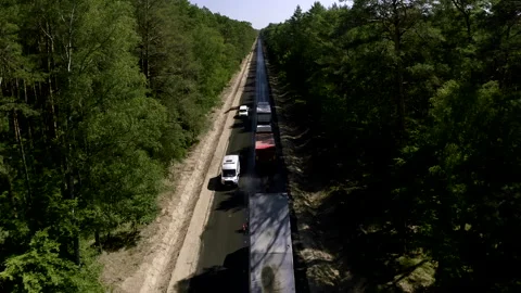 Tilt-down Shot Above A Two-Lane Road In The Middle Of The Green Fields Stock Footage 142004789