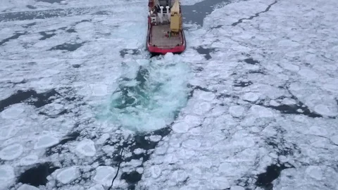 Tilt Down Shot Of Nautical Vessel Moving On Frozen Lake Under Cloudy Sky - 스톡 동영상 233998613