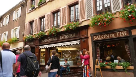 Tilt down shot of old house with cafe on ground floor, unidentified people walk Stock Footage 152248813