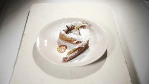 Tilt down shot of a pancake layed on plate in form of a 9 Stock Footage 153058900