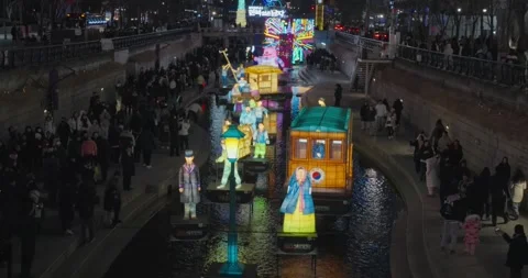 Tilt down shot of Seoul Lantern Festival at night with glowing sculptures and Stock Footage 327372104