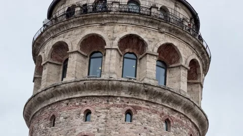 Tilt down shot showcasing the Galata Tower, highlighting its masonry Stock Footage 340155087