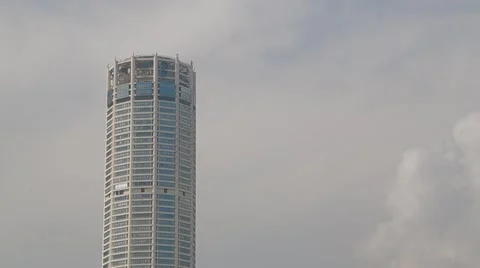 Tilt Down Shot of the Top of Komtar Tower to an Old Ruined Building Stock Footage 48139462