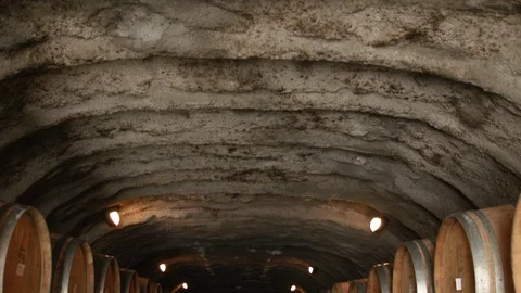Tilt down shot of wine barrels in cave, Queenstown, New Zealand Stock Footage 89811121