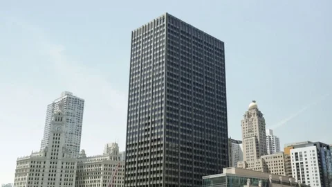 Tilt down from a skyscraper to a river boat in Chicago, Illinois Stock Footage 79699809