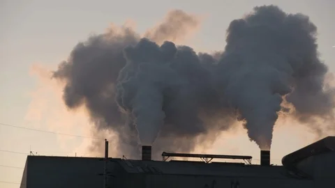 Tilt down on smoke from factory in late afternoon Stock Footage 89945251