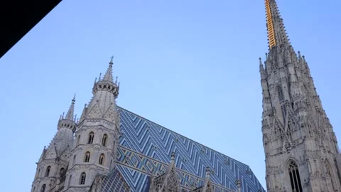 Tilt down from St. Stephen's Cathedral in Vienna City Center on clear day Stock Footage 165342178