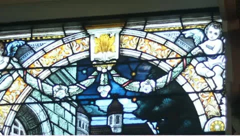 Tilt down stained glass window catholic church depicting mary Stock-Footage 11142956