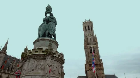Tilt down statue in Bruges Markt with the Belfry Stock Footage 90454061