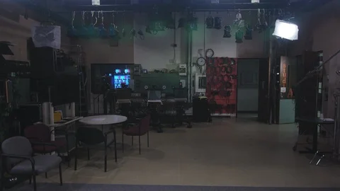 Tilt down from studio lights to small production studio space Stock Footage 89504835