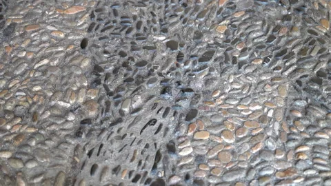 Tilt down textured pebble paving on an Italian street Stock-Footage 346780016