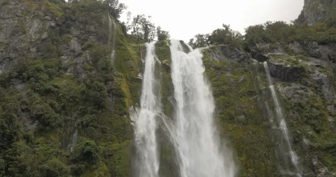 A tilt down in time with the flowing water of Stirling Falls in Milford Sound Stock Footage 120491480