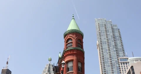 Tilt down from Toronto flatiron tower to busy historic street below Stock Footage 321035650