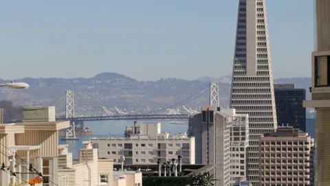 Tilt down to transamerica pyramid and bay bridge, san francisco Stock Footage 83525637