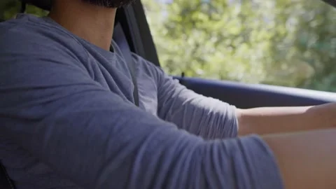 Tilt down video of handsome man driving a car Video stock 157152413