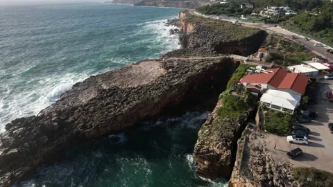 Tilt down view above Boca do Inferno, Hell's mouth cliff in Cascais, Portugal Stock Footage 220862471
