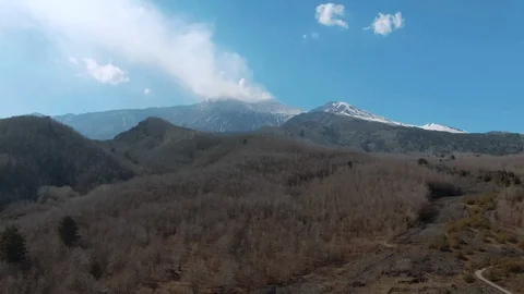 Tilt down view from the summit of mount Eta to lava rock and trees Stock Footage 109260715