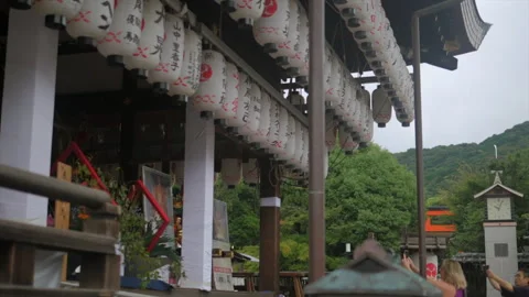 Tilt Down View of Traditional Paper Lanterns Hanging at Shinto Shrine in Kyoto Stock Footage 338156999