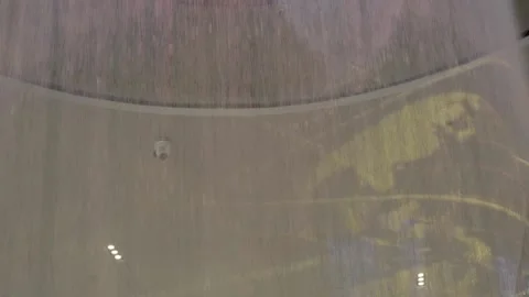 Tilt down water falling slow motion ceiling fountain LGA NYC Queens Stock Footage 260424248