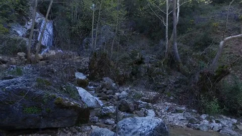 Tilt down on a waterfall feeding a stream at Lassa, Mount Lebanon Stock Footage 108463235