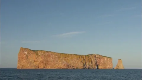 Tilt down to a wide shot of Rocher Perce Stock Footage 81723892