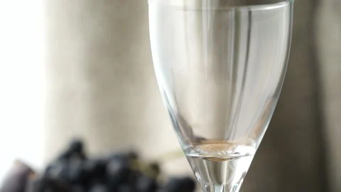 Tilt of an empty glass being filled with wine Stock Footage 232400482