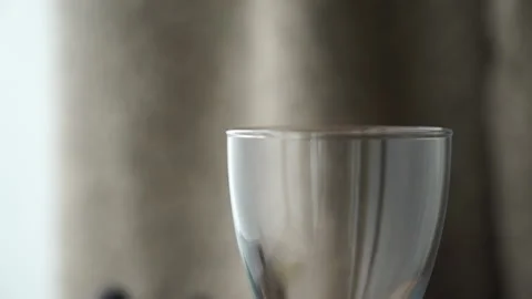 Tilt of an empty glass with wine Stock Footage 232400282