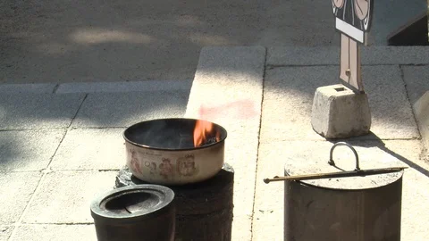 Tilt from fire to cut out of Henro boy holding sign for Okubo-ji temple Stock Footage 86758875