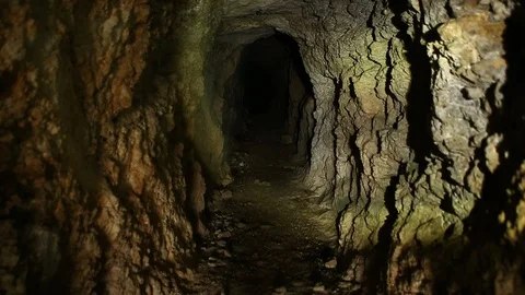 Tilt Up of Flashlight moving around inside of Abandoned Mine Stock-Footage 122903621