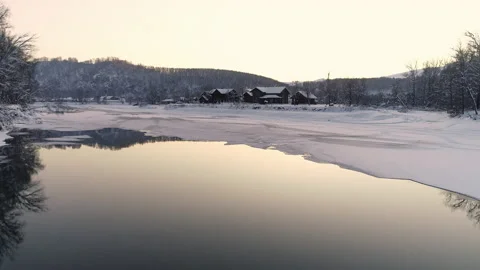 Tilt Flight over the river at sunset. Trees and mountains on the horizon are Stock Footage 136958553