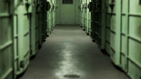 Tilt up from floor to green prison corridor 스톡 동영상 191353579