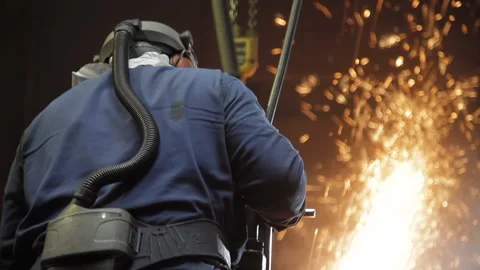 Tilt of a foundry worker using a circular saw Stock-Footage 231496796