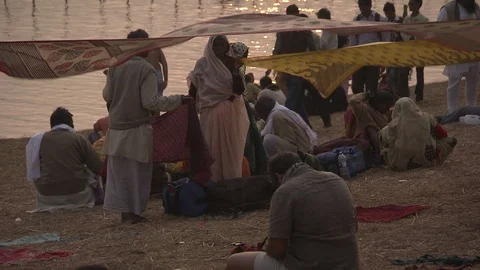 Tilt up to Ganges River with many boats in golden sunlight. Video stock 86760554