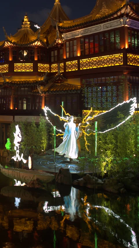 Tilt up from glowing lantern figure to illuminated pavilion in SHANGHAI China 库存影片 344917460