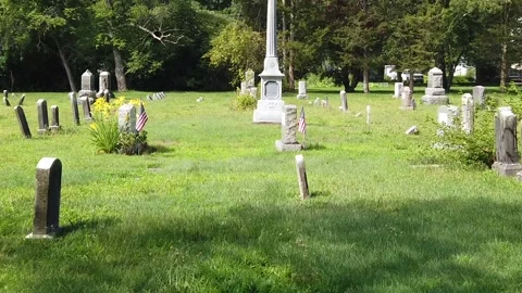 Tilt up from Graves in Cemetery to Clouds in Sky 库存影片 139899704