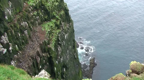Tilt up on greenish cliff Stock Footage 37299972