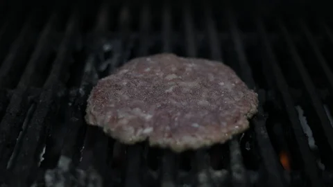 TILT of Grilling Raw Burger Stock Footage 128463683