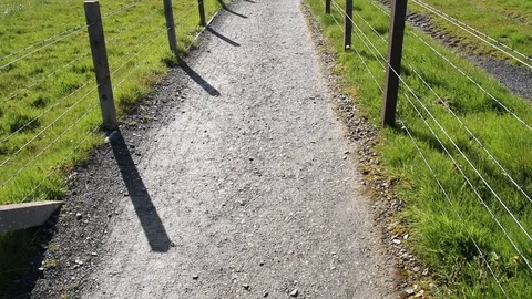 Tilt up from ground to gravel path in between fields Stock Footage 89588418
