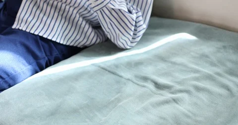 Tilt up handheld shot of boy using digital tablet while relaxing on sofa Stock Footage 119771946