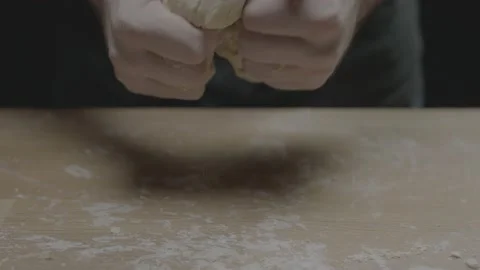 Tilt up to hands messing with dough Stock Footage 149115790