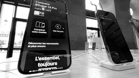 Tilt-up to hero object latest Apple Computers iPhone 14 Pro and Air Pods Max Stock Footage 212944490