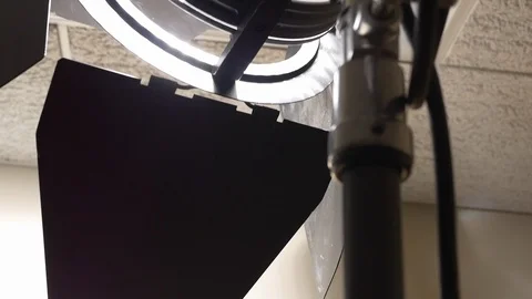 Tilt up of an HMI video light on the set of a video production shoot. Stock Footage 99427251