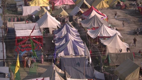 Tilt up from large array of tents during Kumbh Mela, Allahabad, India Stock Footage