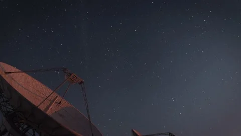 Tilt Up from a Large Radio Telescope Array to the Starry Night Sky Stock Footage 224500661