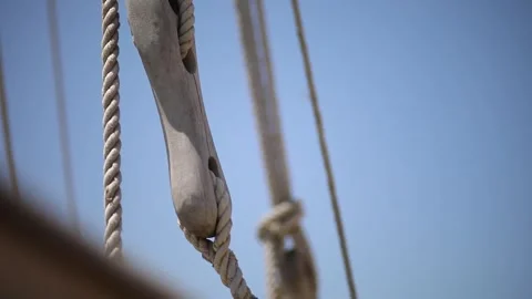 Tilt up to marine ropes on the deck of an old wooden ship, close up. Stock Footage 247128906