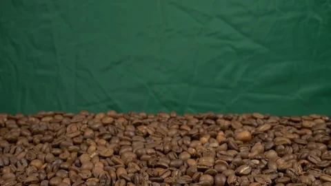 Tilt in out Fried of coffee beans on green screen prores 10bit Stock Footage 101830515