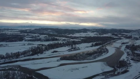 Tilt up over Yellowstone River at dusk in winter Stock Footage 310528131