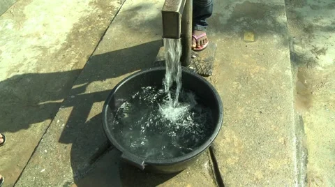 TILT UP ON PAKRO YOUNG MAN PUMPING WATER AT BOREHOLE Stock Footage 58930425