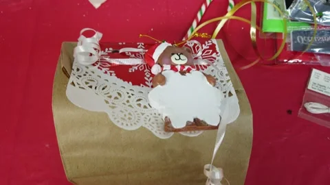 Tilt Up Paper Bag Gift Wrapped With Teddy Bear And Snowflake Holiday Christmas Stock Footage 223386321