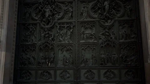 Tilt up real time close up shot of a door Milan Cathedral. A popular tourist Stock Footage 122290565